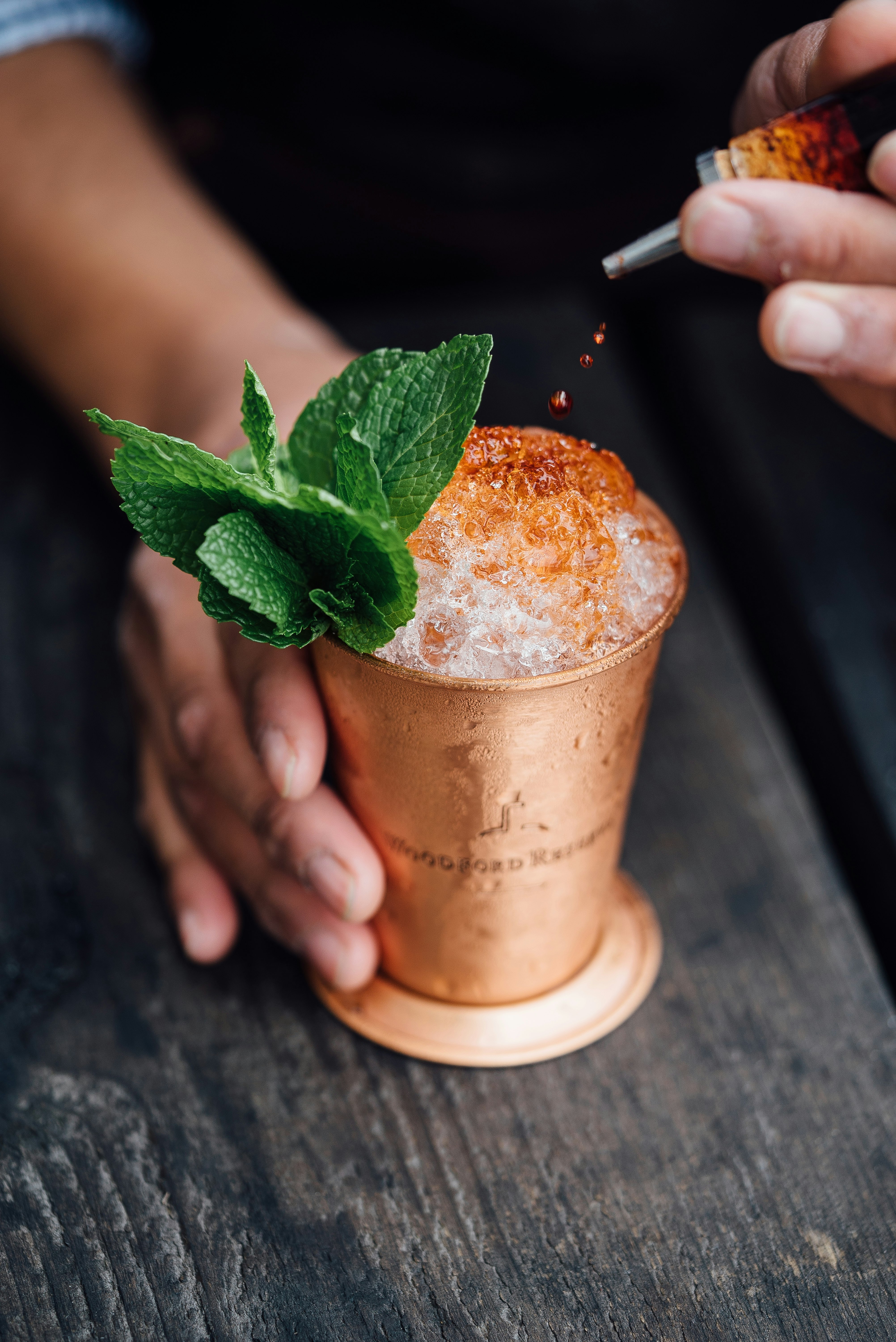 brass-colored cup filled with crushed ice with mint